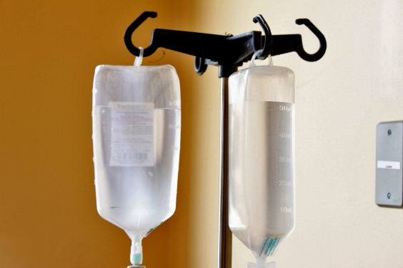 tubo de soro apoiado em tripé. Fundo de parede hospitalar