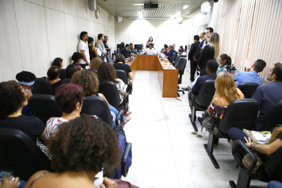Professores e outros servidores escolares assistem, da plateia, as falas dos componentes da Mesa