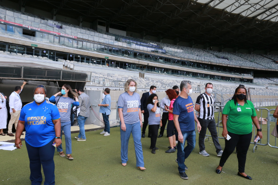 Comissão no gramado do Mineirão. A frente, algumas pessoas vestem a camisa com o slongan da camapanha
