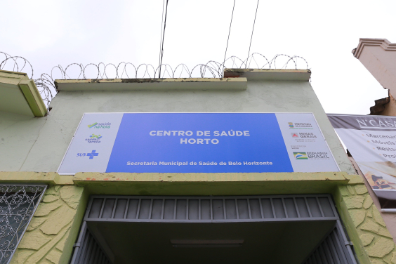 Fachada do Centro de Saúde Horto. Uma placa azul fixada ao alto da entra traz os dizeres : Centro de Saúde Horto