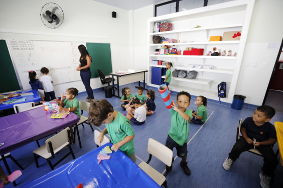 Crianças brincam dentro de sala de aula