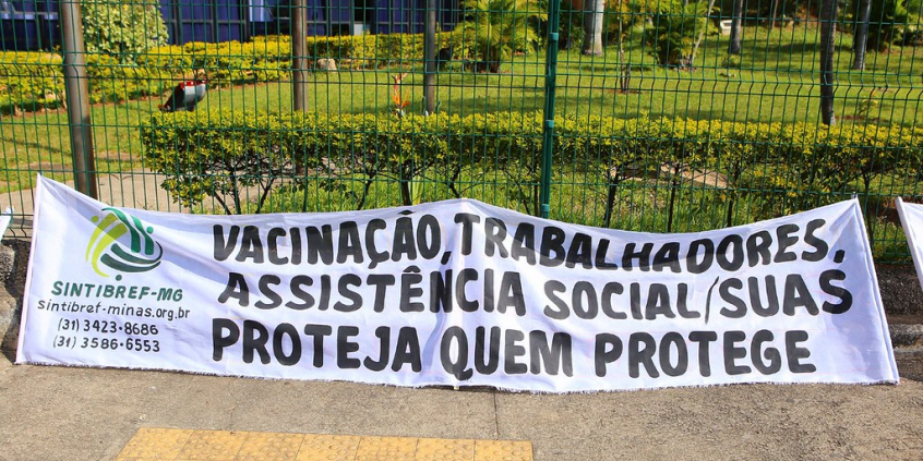 Faixa com os dizeres: Vacinação, trabalhadores do SUAS - Proteja quem protege 