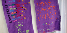 Bordado com nomes de mulheres mortas por feminicídio. Com as inscrições "Não se cale" e "Todas sempre vivas"