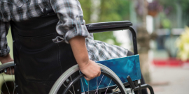foto mostra close de pessoa de costas na cadeira de rodas 