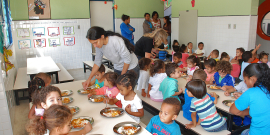 crianças fazem refeição na escola