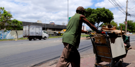Homem empurra carrinho em rua de Belo Horizonte