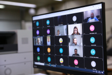 Seis homensw e umamulher dividem tela de computador em conferência remota